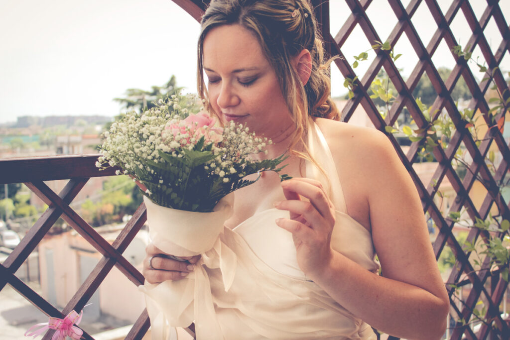 The blonde bride smells the bouquet