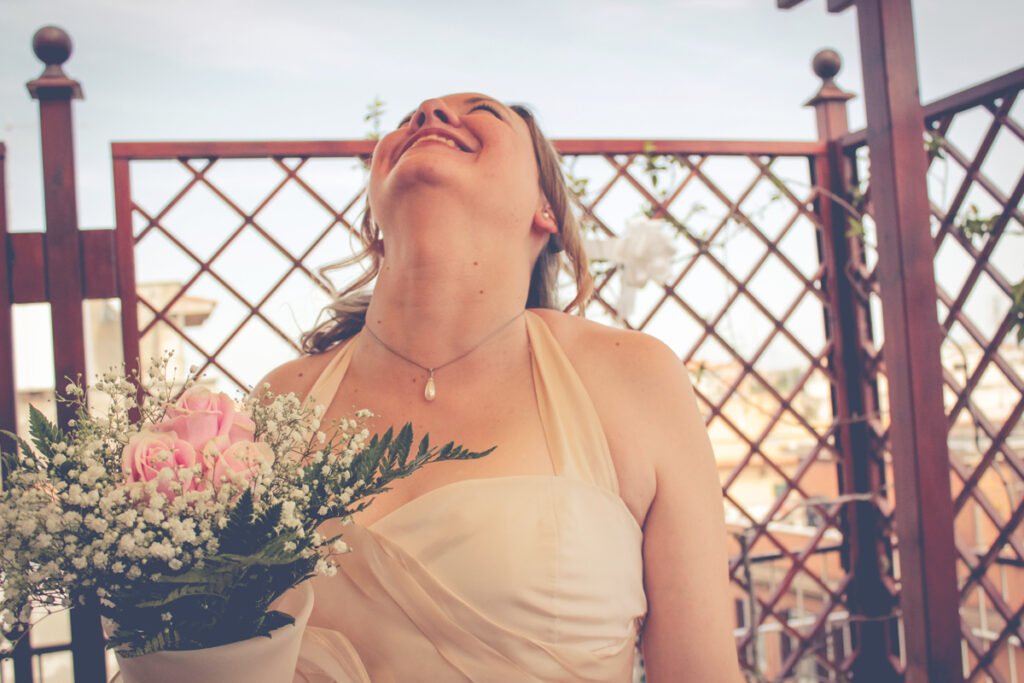 A blonde and happy bride with bouquet in hand 