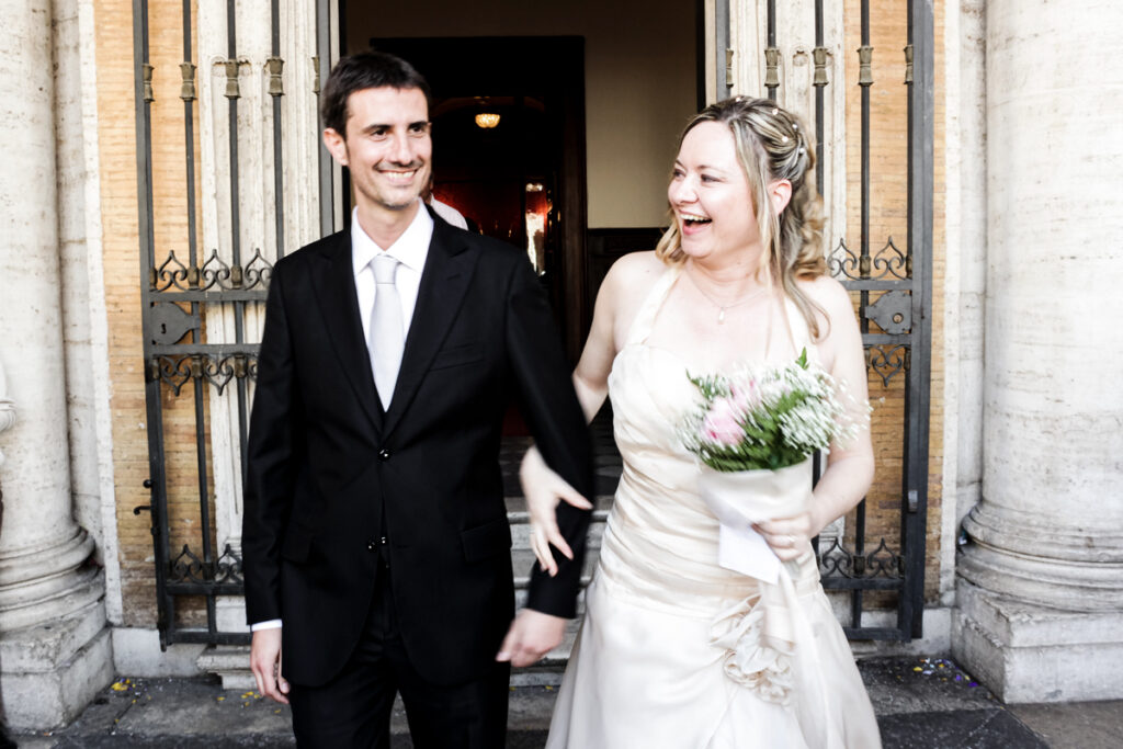 The smiling couple at the end of the ceremony, finally married