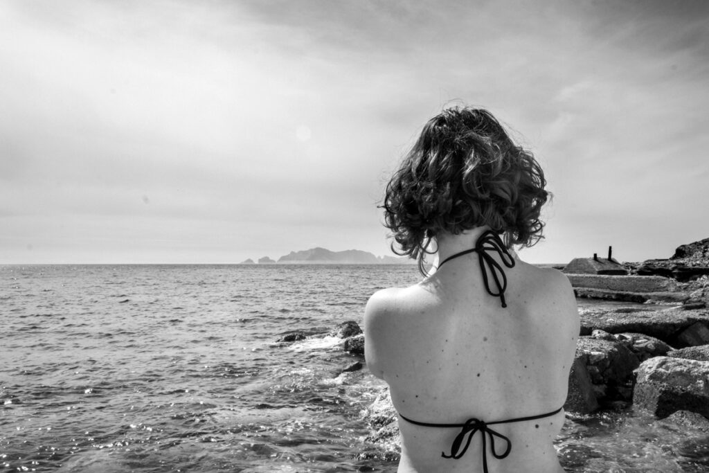 a girl shoulders with the sea in the background