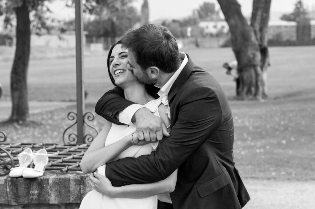 The kiss and embrace of the bride and groom