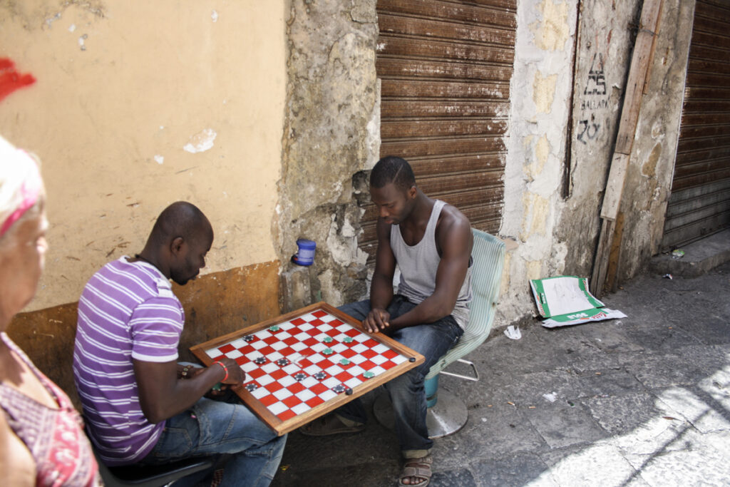 Palermo historic centre, two guys playing in the streets, due giovani giocano a dama per strada, 