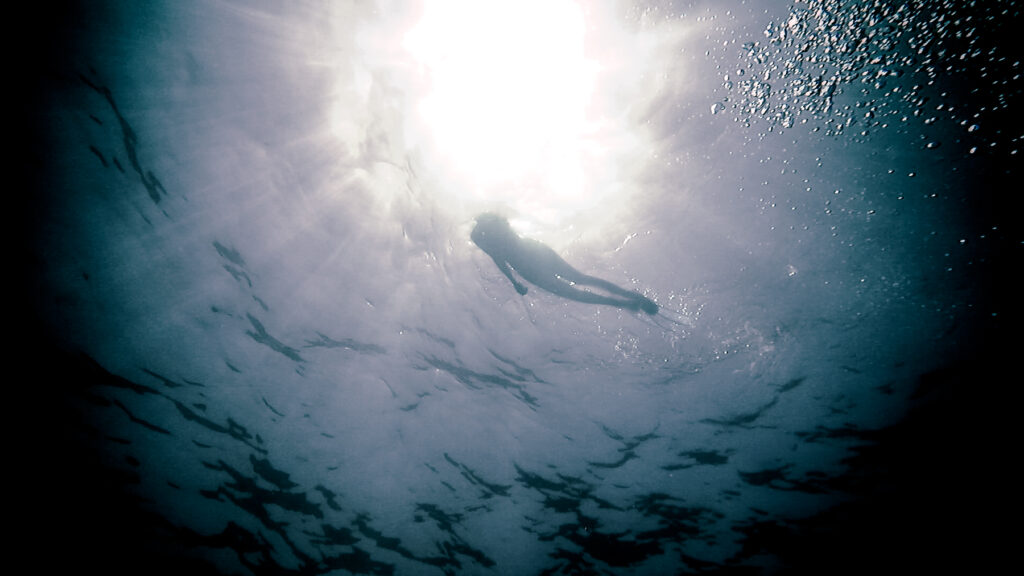 Silhouette of a woman from the deep water. 